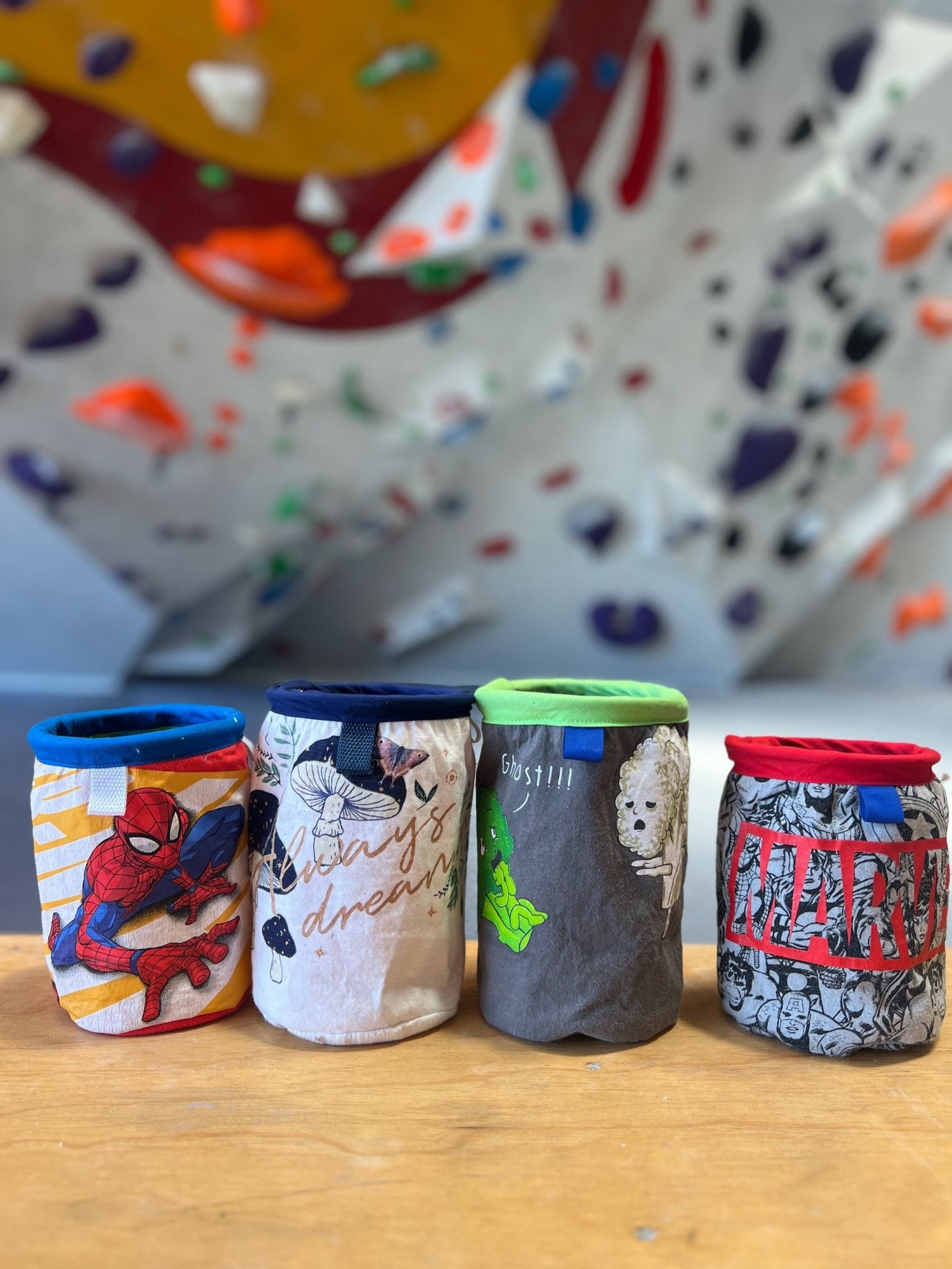 magnetic upcycled chalkbags in front of climbing wall 